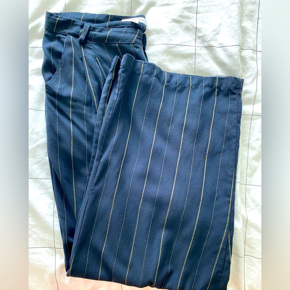 Brand new never worn pinstriped black wide leg pants. Very stylish.